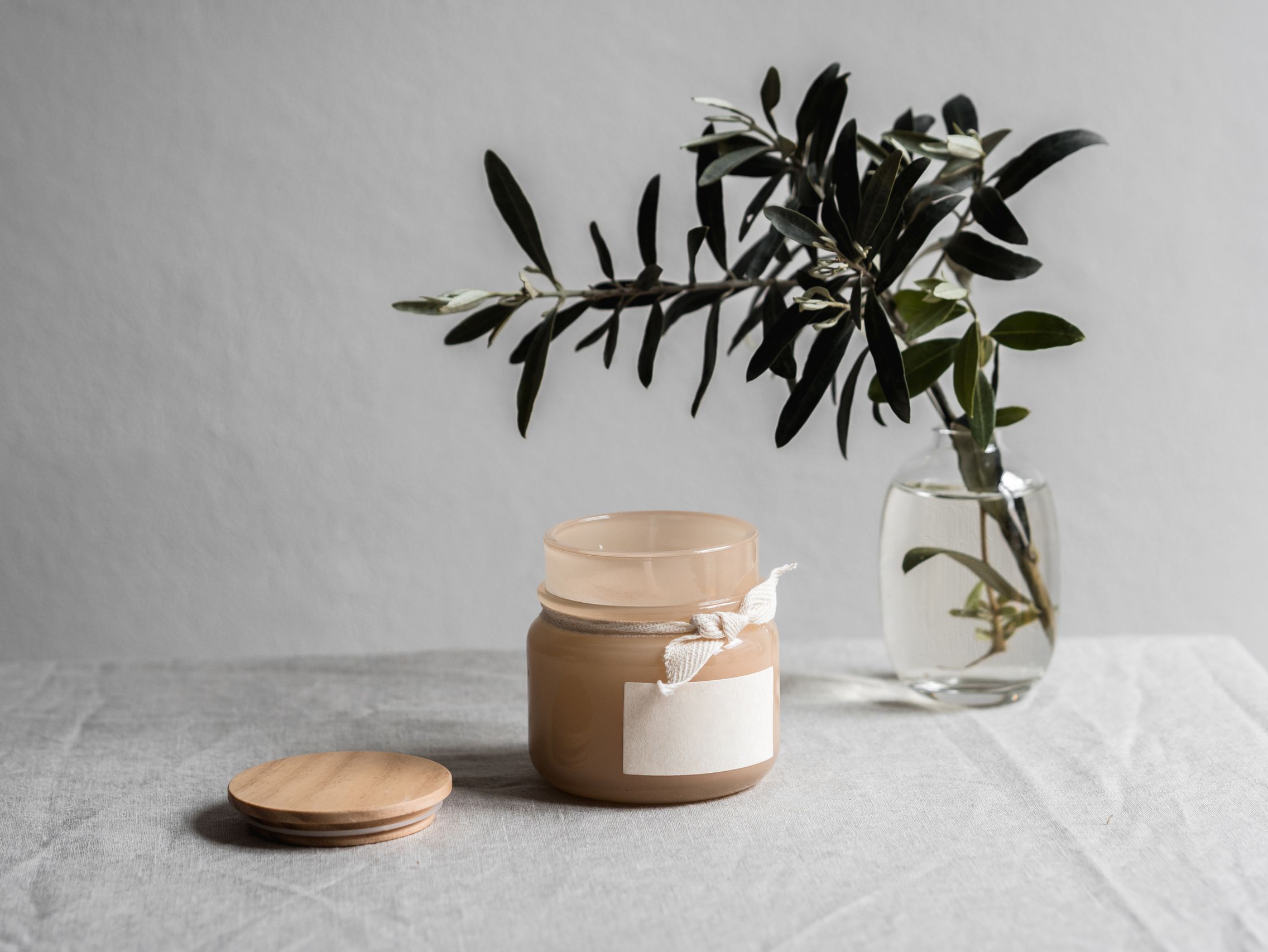 Autumn woods candle next to vase and linen